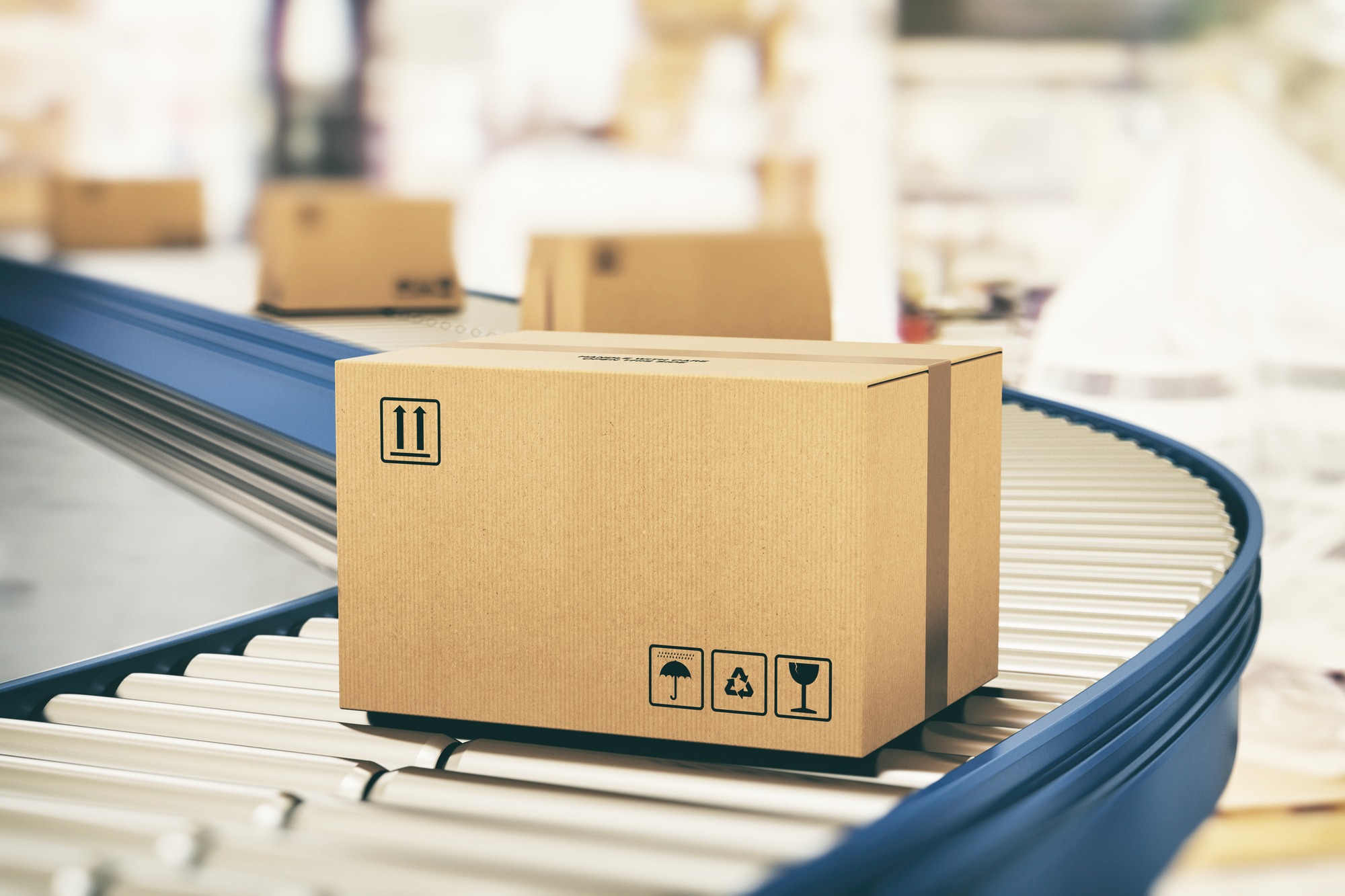 Cardboard boxes on conveyor rollers ready to be shipped by courier for distribution